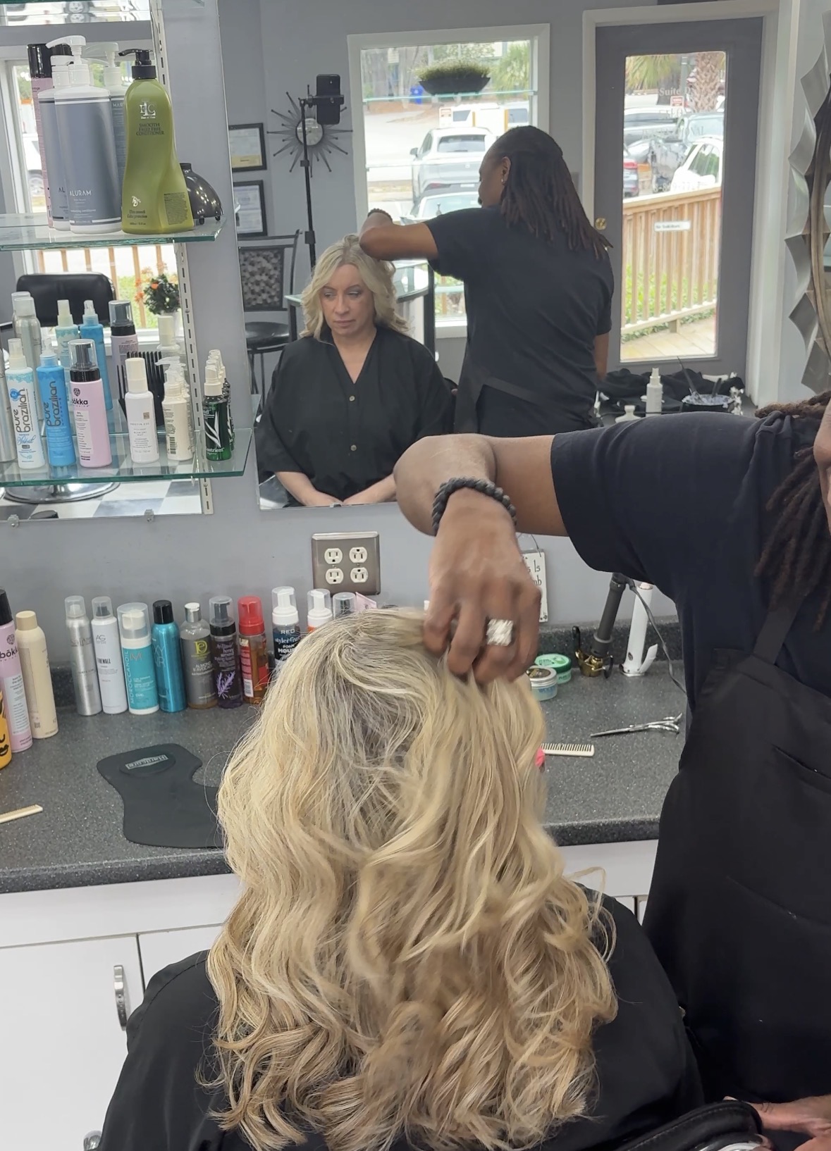 Cashmere blonde hair color with soft face-framing highlights, dimensional lowlights, and a seamless root smudge at Salon International Charleston